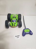 Green Tonka remote control car with black wheels and matching purple controller with green button