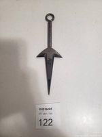 Top view of the titanium kunai sword showing entire blade, guard, handle, and ring.