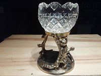 Side view showing crystal bowl and three brass cat figures supporting it