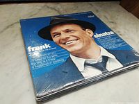 Frank Sinatra vinyl LP with blue cover; portrait of Sinatra wearing a hat and smiling