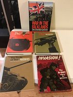 Five military history books arranged on a white surface showing front covers clearly with titles and imagery.