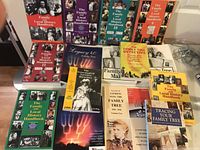 Photo showing a spread of genealogical books with different colors and editions, including multiple Family and Local History Handbooks and Legacy 4.0 Family Tree guide