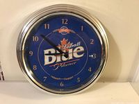 Front view of the Labatt's Blue wall clock with clear view of the logo, numbers, and hands.