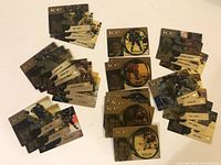 Top down photo showing three groups of McDonalds ICE NHL hockey cards spread on a flat surface. Various players in action poses are visible. Cards have distinctive gold/black ICE design and include rectangular and circular cards.