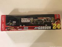 Front view of Jeff Gordon NASCAR diecast truck hauler in box with National Guard graphics and #24 number on cab.
