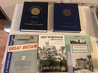 Collection of vintage books related to Great Britain and Normanby Township arranged on a table, showing spines and covers.