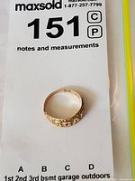 Ring centered on notes and measurements card marked 151