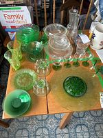 Overhead view of all pieces on table showing plates, glassware, vases, flower frog, lidded compotes and misc.