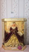 Full boxed view of Special Edition Happy Holiday Barbie doll in burgundy and gold outfit with white fur trim.