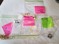 Overview of packaged lot showing bag labeled for costume rings and loose turquoise ring
