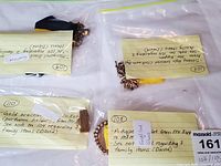 Overview of four jewelry pieces in plastic bags labeled #108, #109, #110, #103