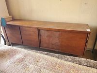 Full front view of the credenza showing sliding doors on right and drawers on left