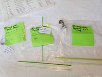 Overview of three labeled bags containing the rings and price notes