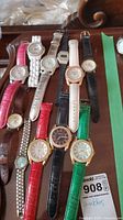 Lot of 11 fashion watches showing variety of leather and metal bands, different dial styles and colors