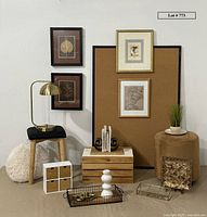 Overall view of the lot showing ottoman, stool, lamp, framed art and bulletin board, decorative trays, crate, and pillow