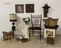 Full arrangement showing all items including brass candlesticks, chair, lamp, pillows, and framed artworks