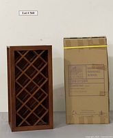 Photo showing wood wine rack cabinet next to its original cardboard packaging box with branding and model details.