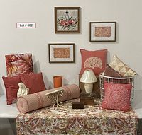 View of full lot showing framed artwork, pillows, lamp, planter, basket, tablecloth, and bolster pillow arranged on table and wall