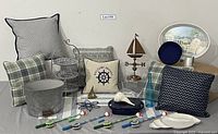Overview of all items including pillows, sailboat pail, three-tier plate rack, nautical decor, and toys