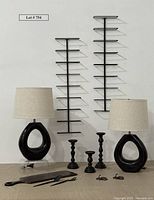 Full lot displayed against white background showing both lamps, the two wine racks on the wall behind, three black turned metal holders/hooks, wooden charcuterie board, and the MCM style metal salad tongs on board.