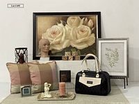 Photo showing the lot with large framed white rose print, smaller floral artwork, mannequin head, candles, pillows, handbag, dice, tray, and decorative figures.