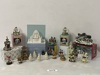Full lot overview of all Pfaltzgraff water globes and assorted holiday music boxes and figurines.
