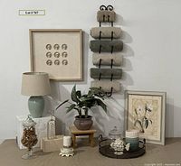 Full lot arranged on table and wall, showing iron towel rack, framed art, plant, lamp, trays, and decor items