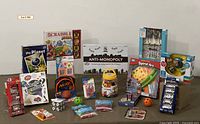 Full lot overview showing assortment of new toys and games, diecast cars, and educational items unopened in original packaging.