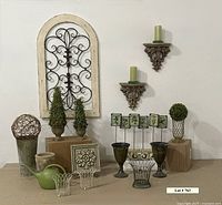 Full display showing all items in lot including wall arch, topiaries, herb markers, vases, watering cans, shelves, coasters, candles, and decorative pieces.
