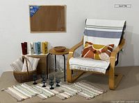 Full lot showing chair, blanket, pillow, bowls, placemats, glasses, cork board, and small side table