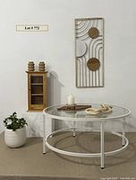 Overall lot showing arrangement of coffee table, display cabinet, wall decor, wooden tray, vases, candle with holder, wooden chain, and plant pot.