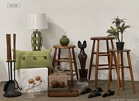 Full overview of the entire lot with fireplace tools set, stools, lamp, green pillow, plant stand, wooden and ceramic decor items, and glassware.