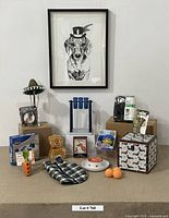 Full lot showing black and white framed dachshund artwork and various dog toys, boots, hat, and treat dispensers arranged below.