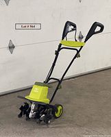 Sun Joe electric garden tiller front and side view showing green and black color, wheels, handles, and metal tines
