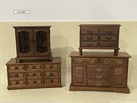 Four vintage Japanese wooden jewelry boxes displayed together from the front showing drawer layout and hardware