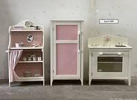 Front view of three wooden play kitchen units (hutch, fridge, stove)