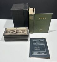 Photo showing the hardcover book, 41 stereoview cards stacked, black box, and folded map booklet.