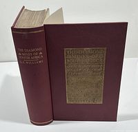 Front and spine view of the hardcover book showing maroon cover with gold embossed title.