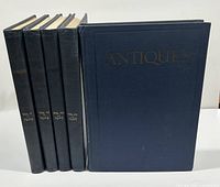 Five hardcover volumes of 'Antiques' arranged vertically showing black cloth spines with gold embossed text indicating volumes and years 1924 to 1926.