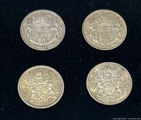 Four Canadian half dollar coins, date and reverse side showing Canadian coat of arms.