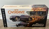 Front of Anki Overdrive Fast & Furious Edition box showing graphics of two detailed mini supercars in motion.
