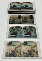 Stack of colorized WWI military stereoview cards showing soldiers, artillery, and battle scenes.