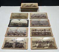 Stack of approximately 45 stereoview cards with a spread of nine cards in front showing battlefield scenes