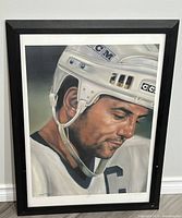 Frontal view of the entire framed art print showing Doug Gilmour in hockey helmet and uniform, signed and numbered.