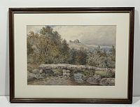 Full view of framed watercolour painting showing stone bridge, river, trees, and hills.