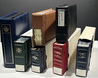 Front view showing three larger binders and four smaller binders