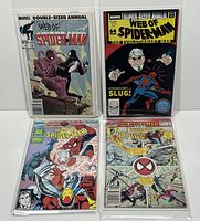 Four Marvel Web of Spider-Man Annual comics in protective sleeves showing front covers: Double-Sized Annual #1, Super-Sized Annual #4, Annual #7, Annual #8