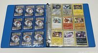 Blue binder open showing plastic sleeves with 9 Pokémon cards per page on the right; backs of cards visible on left showing Pokéball design.