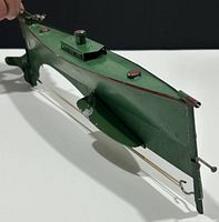 Side angle showing the submarine's shape, propeller, fins and elastic band mechanism.