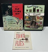 Photo showing original vintage box with colorful artwork, fly tying kit inside with materials and tools, and instruction booklet laid out in front
